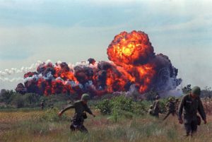 A napalm strike erupts in a fireball near U.S. troops on patrol in South Vietnam, 1966 during the Vietnam War. (AP Photo)